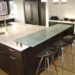 Glass countertop and bar seating in modern kitchen